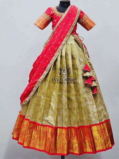 A half-saree style lehenga with a mustard-colored Banarasi skirt and a red blouse. The outfit is completed with a red embroidered dupatta.