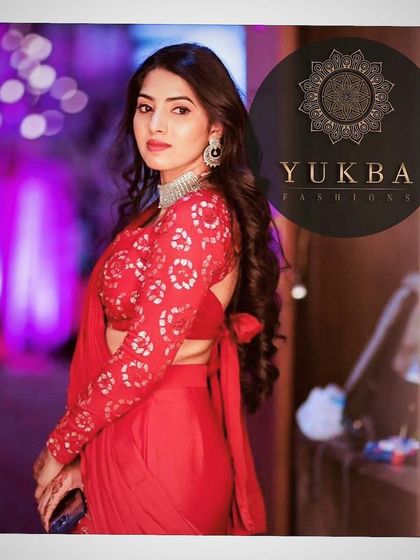 A close-up of the client in her red outfit, highlighting the bandhani-inspired print on the blouse and the modern choker she paired with it.