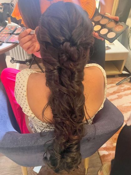 The finished messy fishtail braid, a romantic and bohemian choice for a modern bride.