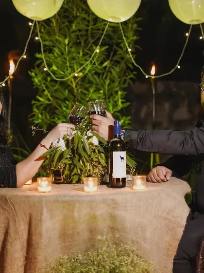 Following the proposal, we documented the couple's private celebration. This shot shows them toasting to their future at a beautifully arranged, candlelit dinner table.
