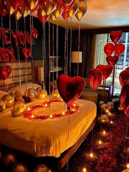 For a truly romantic gesture, we can transform any room into a luxurious retreat. This surprise setup includes a candle-lit rose petal pathway, heart-shaped balloons, and "I Love You Baby" foil letters sentimientos on the bed.