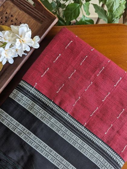 This red Ilkal saree features delicate threadwork motifs on the body, adding a unique touch to the traditional design.