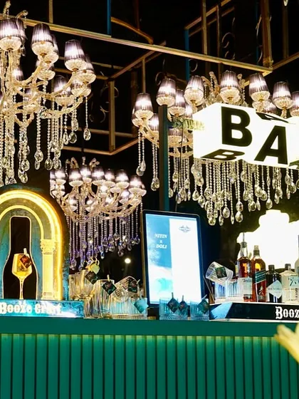 A closer look at the stylish bar, featuring custom "Booze Cruz" signs and elegant lighting. Every detail is curated to match the event's theme and elevate the guest experience.