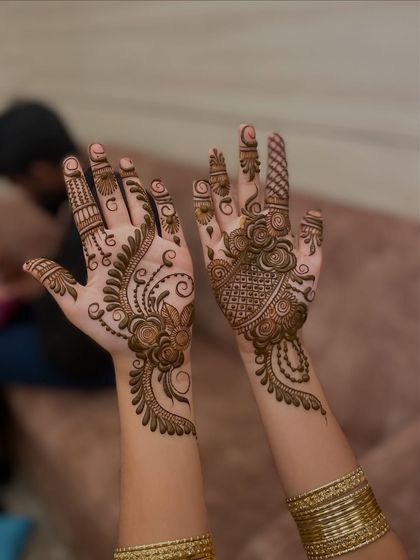 An elegant floral vine design. One hand has a fuller design, while the other has a lighter, complementary pattern, creating a stylish, asymmetrical look.