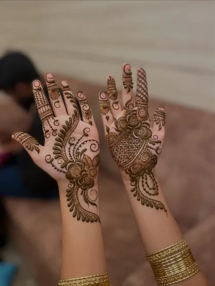 An elegant floral vine design. One hand has a fuller design, while the other has a lighter, complementary pattern, creating a stylish, asymmetrical look.