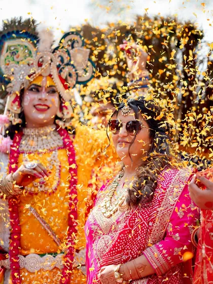 A shower of flowers for the bride, surrounded by her loved ones. These are the moments of collective celebration we live for.