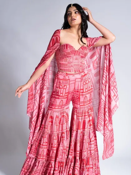 A bold, coordinated look for Label Shivani Nirupam. The makeup features a soft smokey eye and a pink lip to match the dramatic printed outfit.
