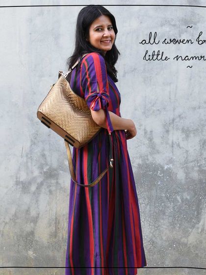 Tulika showcasing the All Woven Bronze Little Namrata as a chic shoulder bag.