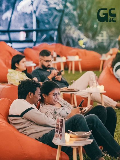 A candid shot of guests enjoying the comfortable beanbag seating on the lawn, a popular choice for our Sunday events.