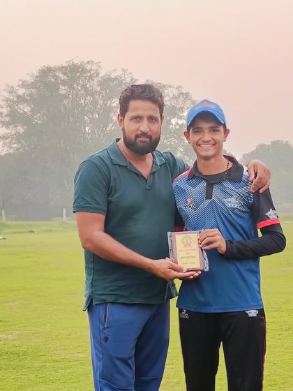 Preet Malik receiving the Best Batsman award for his performance in the same match.