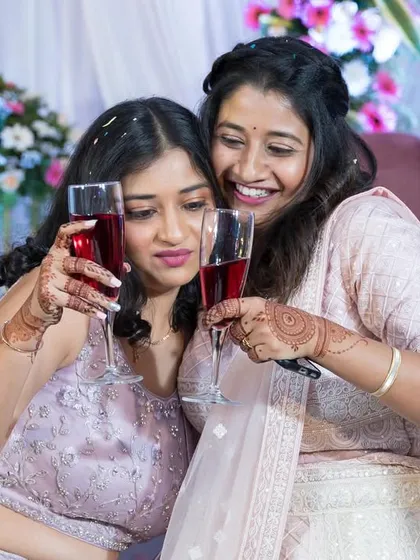 The bride and her friend or sister sharing a toast.