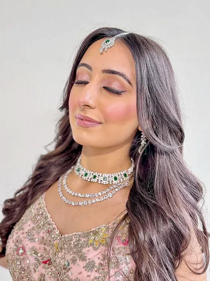 Eyes closed, this shot focuses on the delicate pink eyeshadow and the flawless, dewy skin.