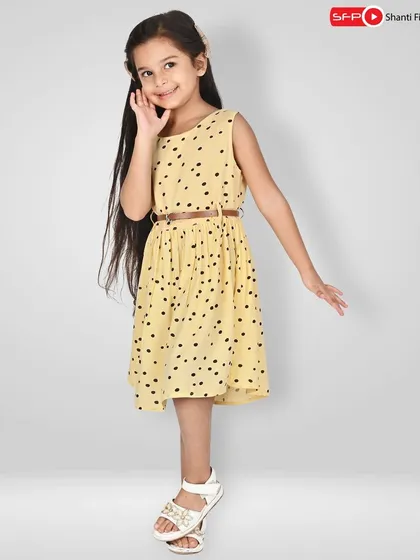 A charming shot for a kids' wear brand, featuring a young model in a polka-dot dress. We work with child models to create playful and appealing images for your collection.