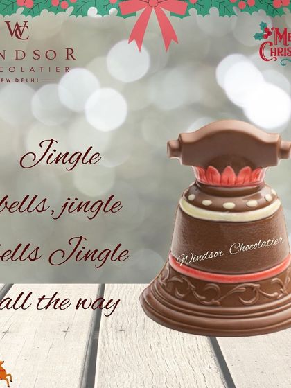 Ring in the holidays with this detailed chocolate Christmas bell, featuring intricate patterns and colorful highlights.
