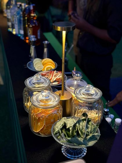 My bar setup includes a variety of fresh and dehydrated garnishes, like oranges, lemons, and herbs, allowing for beautiful and flavorful custom cocktails.