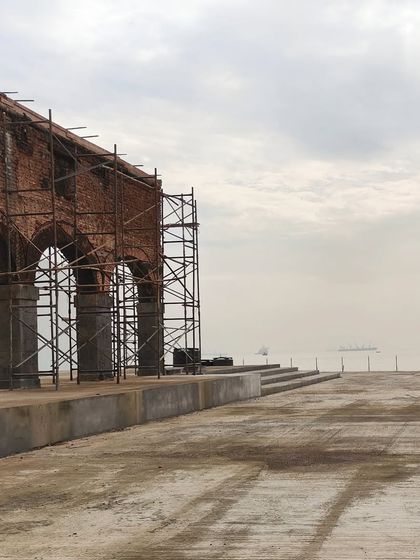 A wide shot of our restoration project site, with the historic brick arches overlooking the sea. This image captures the scale and unique context of the project, blending heritage architecture with a stunning natural backdrop.