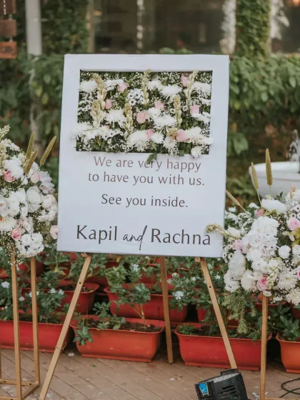 A warm and personal welcome for guests at this dreamy reception. The sign, framed by beautiful pastel floral arrangements, set the tone for a memorable and heartfelt evening.