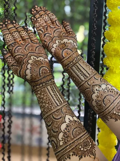 A full bridal design, created with love and dua. Every line, from the delicate paisleys to the fine checks, is drawn to celebrate your unique story. This is a classic intricate Indian bridal henna, covering the arms for a complete look.