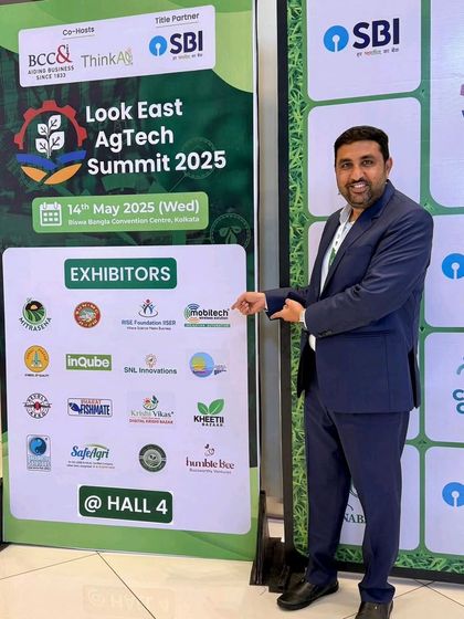 Our Director pointing to our logo on the exhibitor list at the Look East AgTech Summit 2025.
