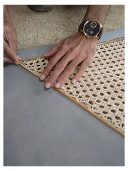 Craftsmanship is at the heart of my work. This image shows the meticulous process of inlaying handwoven cane, a natural material that adds texture and a retro feel to modern furniture. I collaborate closely with skilled artisans to bring these details to life.