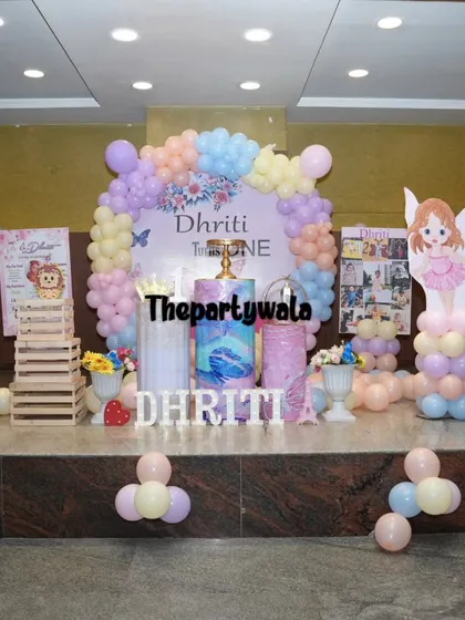 A wide shot of a fairy tale stage setup. The combination of the backdrop, balloon columns, and themed pedestals creates a complete and impressive look.
