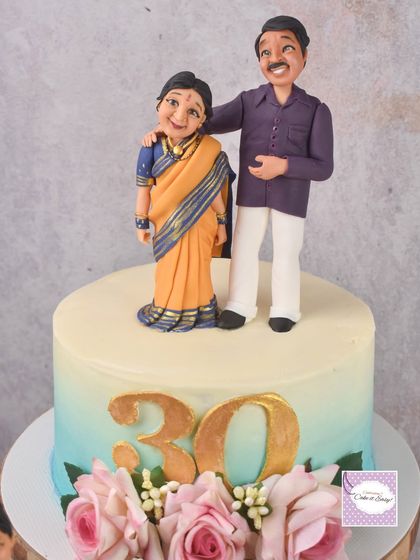 This cake was part of a trio for a combined anniversary celebration, featuring a custom couple topper in traditional attire. I'm getting better at draping these tiny fondant sarees with every cake I make!