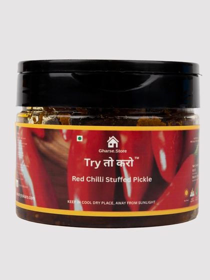 A smaller jar of Red Chilli Stuffed Pickle, isolated on white.