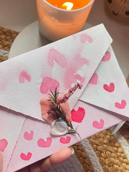 The back of the hand-painted envelope, sealed with wax and a sprig of dried flowers. The presentation is just as important as the card itself!