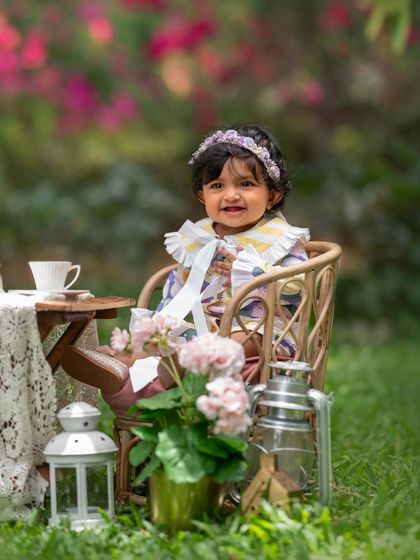 A tea party for one! This outdoor setup with a tiny table and chair is just perfect for a whimsical toddler photoshoot.