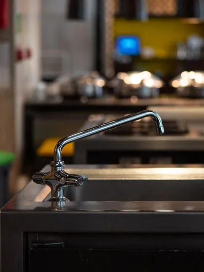 An on-location shot of a T&S Brass faucet in a commercial kitchen. This image showcases the product's durability and suitability for professional environments.