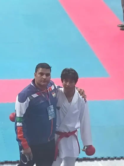 A quiet moment of guidance with one of my students on the competition mat. My role as a coach extends to providing ringside advice and mental support during the most crucial moments of a match.