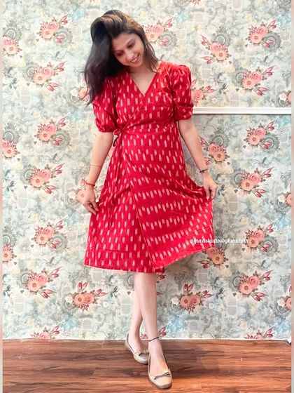 A full-length view of the red Ikat Angrakha dress, styled with elegant footwear. It's a perfect outfit for festive occasions or celebrations.