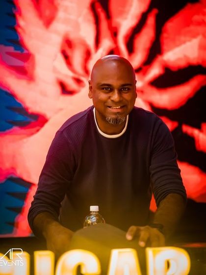 A shot of me at the console at Sugar Factory, with a vibrant, abstract visual on the screen behind me. The production value at my events is always top-notch.