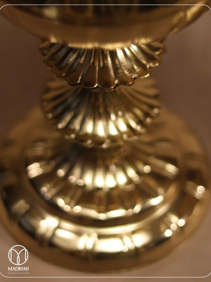 The base of the Mughal Gold Jar, showcasing its tiered, sculptural form. Every part of this piece is designed to convey a sense of luxury and timelessness.