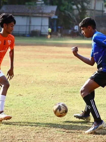 A one-on-one battle for possession, highlighting the competitive nature of our matches.