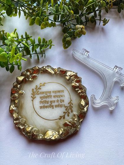 A geode-style mantra plate with the Vakratunda Mahakaya mantra. The gold stones around the edge give it a luxurious and spiritual feel, perfect for a modern home altar.