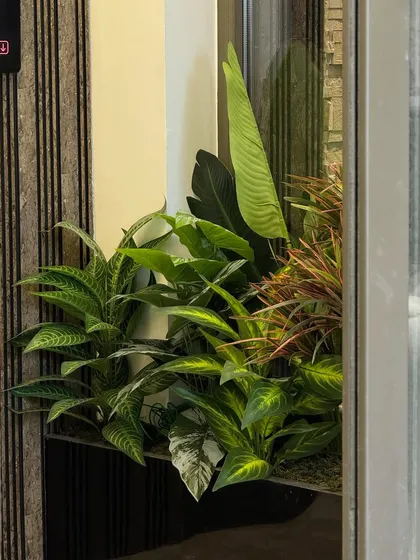 A detailed shot of the varied foliage in one of our custom artificial planters. We focus on realism to ensure our arrangements look beautiful and natural from every angle.