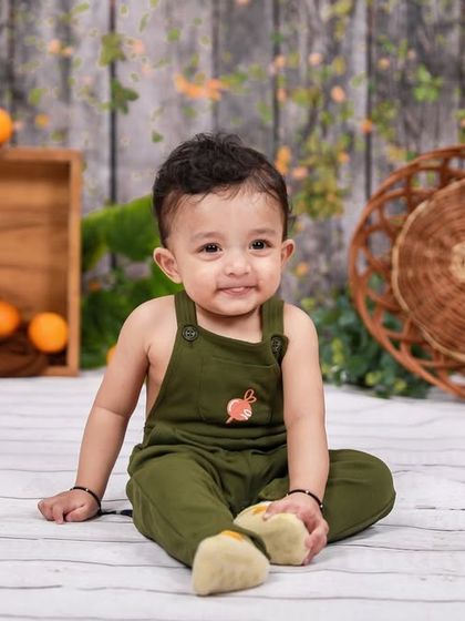 Another angle from a sitter session, capturing a sweet and curious expression. The simple props and background ensure a timeless feel.