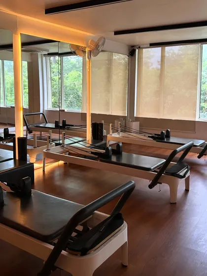 A calm moment before the class begins. The natural light and warm wood floors create a peaceful space to focus on your mind-body connection.