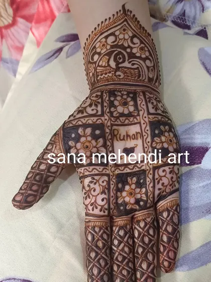 Another example of a personalized design, with the name 'Ruhan' integrated into a checkered pattern. The peacock cuff adds a traditional touch.