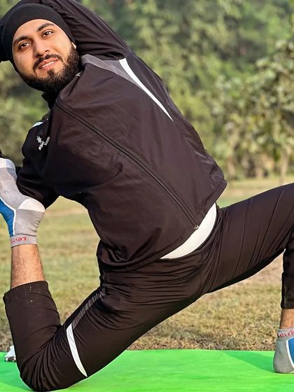 I am practicing Eka Pada Rajakapotasana (One-Legged King Pigeon Pose) outdoors. This advanced pose deeply opens the hips and chest.