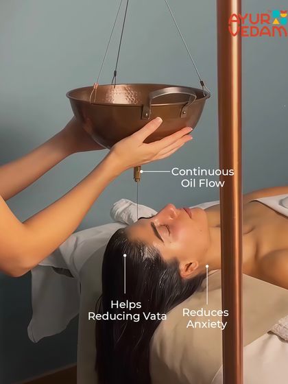 The Shirodhara setup in action. The continuous flow of oil from the copper vessel is key to helping reduce Vata dosha imbalance, which is often linked to anxiety and restlessness.