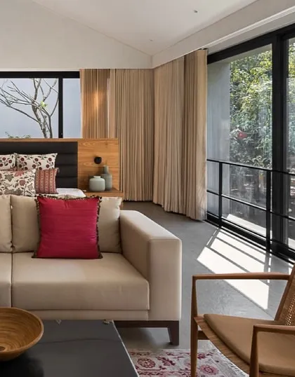 This master bedroom is designed as a serene retreat, with large windows opening directly to the landscape. The clean lines, natural materials, and uncluttered layout create a tranquil atmosphere that promotes rest and connection with the outdoors.