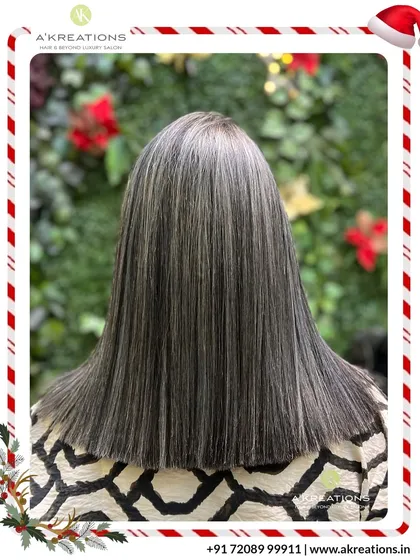 A sleek and modern take on highlights. The straight styling showcases the precise placement of these cool-toned streaks for a chic, polished finish.