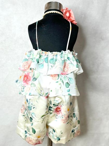 Summer vibes in a classic floral print. This set includes a tiered, ruffled halter top in floral georgette with matching shorts in Dutch satin.