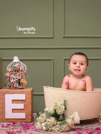 A sweet expression from the birthday boy in his floral bath. These milestone sessions are designed to be comfortable and fun for the little ones.