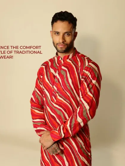 Experience the comfort and style of traditional Indian wear. This vibrant red and orange striped kurta is all about culture and making a bold statement.