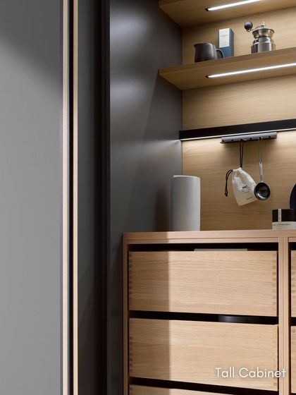 A close-up of a tall cabinet interior with integrated lighting and storage. Every detail is considered to maximize functionality and create a beautiful user experience.