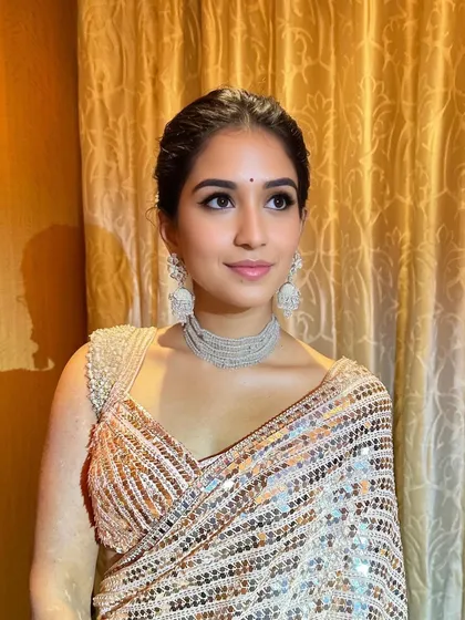 Another beautiful shot of this festive look. The makeup is soft and pretty, with a focus on clean skin and defined eyes, perfect for a traditional celebration.