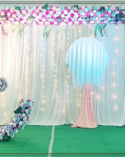 A full view of our pastel-themed crescent moon cradle stage. The setup includes a lighted backdrop and floral stands, creating a complete and beautiful picture.